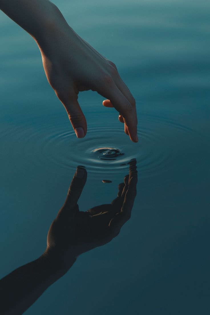 A hand touching water representing sensory experience and empiricism